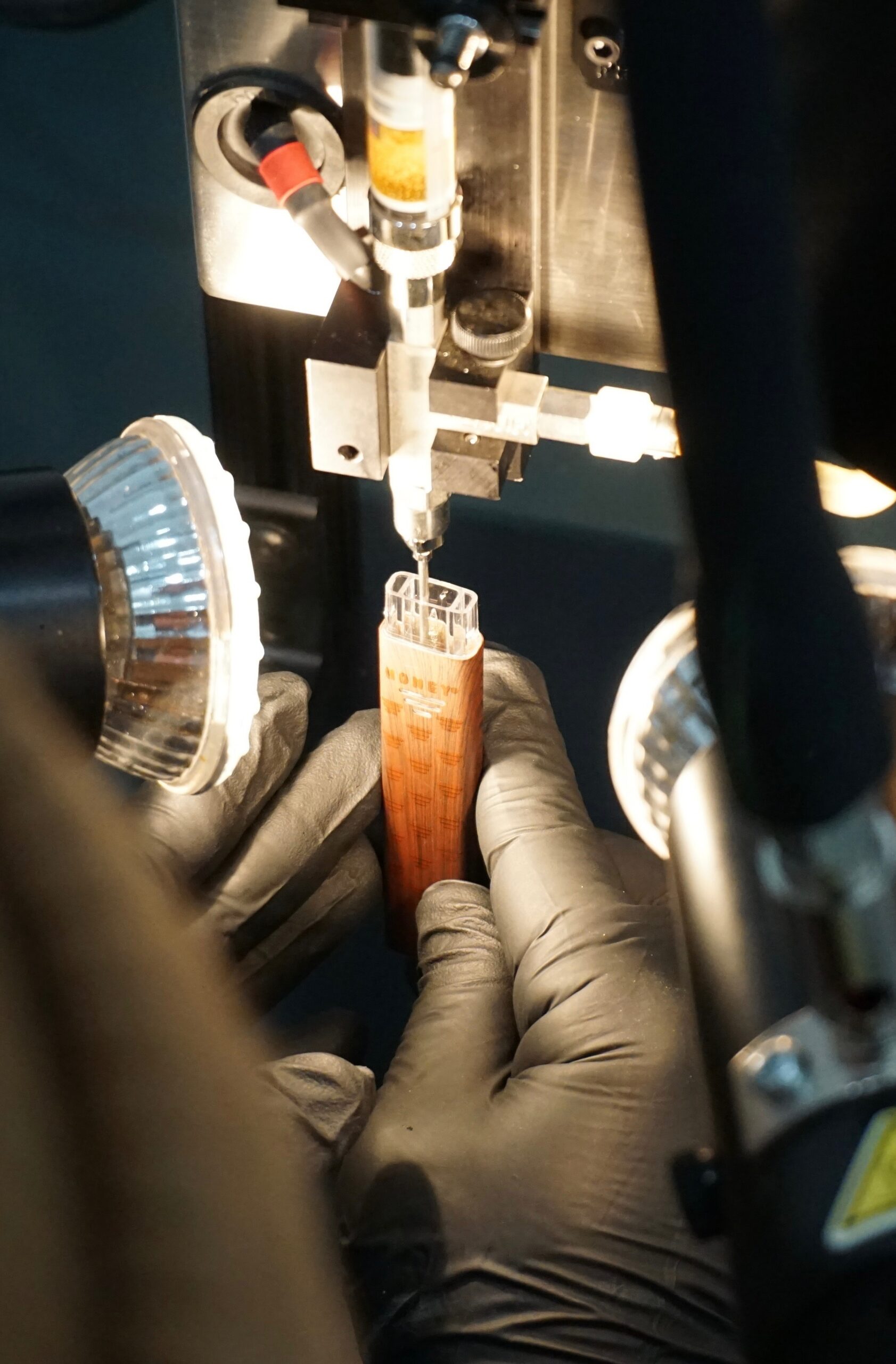 Technician filling cannabis vape cartridges designed with zirconia ceramic technology for contamination free vapor